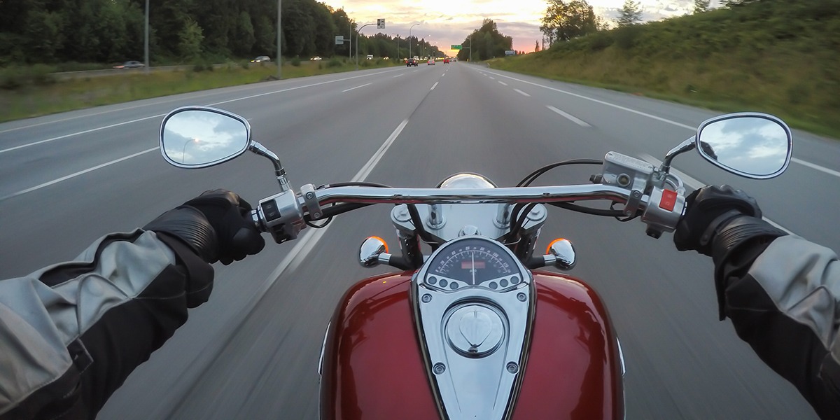 Riding a motorcycle during a vibrant sunset