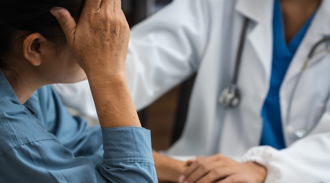 woman being comforted by doctor after medical misdiagnosis